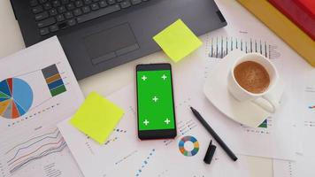 Business office desk with green screen smartphone video