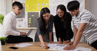 Front view of hand businesspeople pointing and explaining the information on the paper with team in the meeting room. Businessman and businesswoman meeting on sales pitch. video