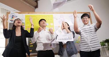 Group of asian businesspeople team standing in conference together in office and throw graph and chart papers into the air. Idea for a good relationship of teamwork in business. Business success. video