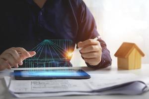 House plan design, house structure blueprint. Engineers use tablets to design blueprints and analyze building structures. Architect concept, technology in design photo