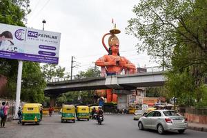 New Delhi, India - June 21, 2022 - Big statue of Lord Hanuman near the delhi metro bridge situated near Karol Bagh, Delhi, India, Lord Hanuman big statue touching sky photo