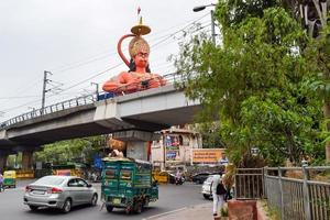 New Delhi, India - June 21, 2022 - Big statue of Lord Hanuman near the delhi metro bridge situated near Karol Bagh, Delhi, India, Lord Hanuman big statue touching sky photo