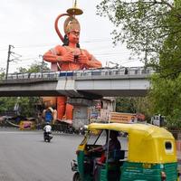New Delhi, India - June 21, 2022 - Big statue of Lord Hanuman near the delhi metro bridge situated near Karol Bagh, Delhi, India, Lord Hanuman big statue touching sky photo
