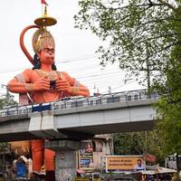 New Delhi, India - June 21, 2022 - Big statue of Lord Hanuman near the delhi metro bridge situated near Karol Bagh, Delhi, India, Lord Hanuman big statue touching sky photo