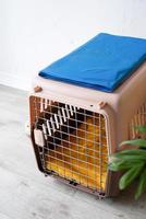 plastic pet carrier or pet cage with yellow travel case on the floor at home, pet corner plastic pet carrier or pet cage with yellow travel case on the floor at home, pet corner photo