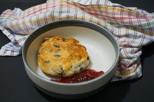 Cottage cheese pancakes syrniki with strawberry jam close up photo