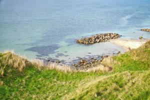 Hundested, Denmark on the cliff overlooking the sea. Baltic Sea coast, grassy photo
