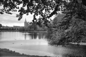 Frederiksborg castle park in black and white, with created lake, in the background the castle photo