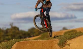 The image of the cyclist, symbolizing the descent from the bike down the hill. photo