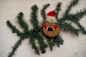 santa claus decoration on a fir branch in december photo