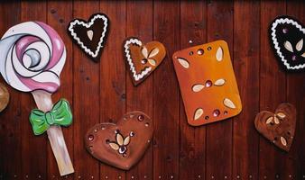 gingerbread and candy decoration for christmas on a wooden wall photo