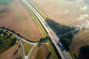 Car traffic on highway at summer day, aerial view photo