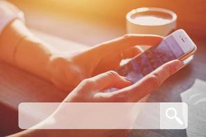 Woman in cafe using smartphone to search data online photo