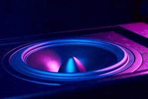 Sound audio speaker with neon lights on dark background photo