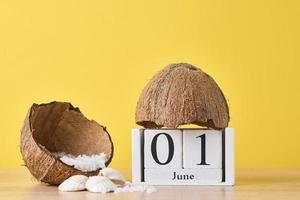 Wooden block calendar with date June 1 on the yellow background photo