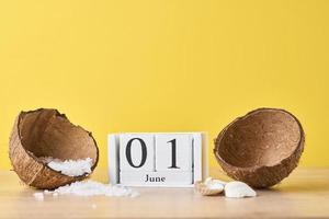 Wooden block calendar with date June 1 on the yellow background photo