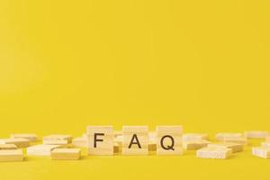 Wooden blocks with abbreviation FAQ on the yellow background photo