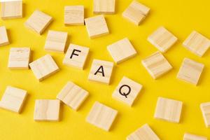 Wooden blocks with abbreviation FAQ on the yellow background photo