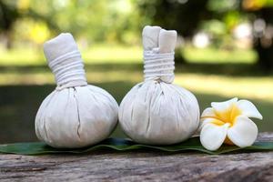 Compress ball with Thai herbal and Flower Candles. Spa concept. photo