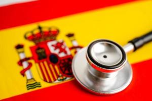 Black stethoscope on Spain flag background, Business and finance concept. photo