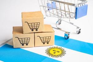 Box with shopping cart logo and Argentina flag, Import Export Shopping online or eCommerce finance delivery service store product shipping, trade, supplier concept. photo