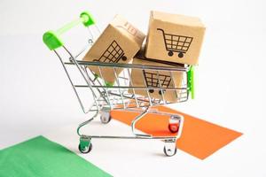 Box with shopping cart logo and Ireland flag, Import Export Shopping online or eCommerce finance delivery service store product shipping, trade, supplier concept. photo