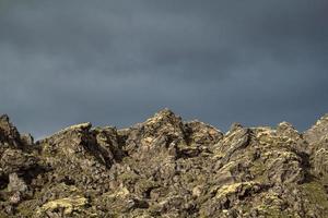 Mountain slopes with overcast sky landscape photo