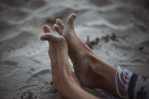Close up funny feet on sandy beach concept photo
