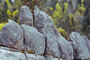 Huge ancient stones in forest landscape photo