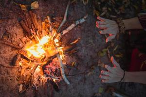 Close up hands over campfire concept photo
