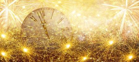 Fireworks New Year Clock.Countdown New Year's clock.Clock that marks a few minutes to the new year with torches and fireworks.Twelve Oclock New Years. photo