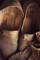 Rustic straw slippers with gloves. Vertical image. photo