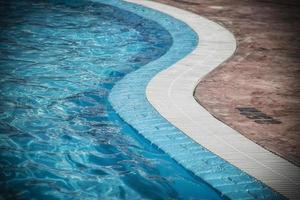 Edge of a swimming pool with depth markings photo