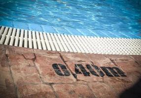 Edge of a swimming pool with depth markings photo