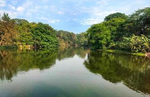 Scenic view of Chandrika Devi Temple with river and greenery photo