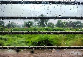 Closeup image of water droplets on the window of running train d photo