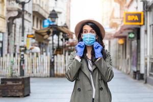 Girl in respiratory mask. Cold, flu, virus, tonsillitis, respiratory disease, quarantine, epidemic concept. Young woman on the street wearing face protective mask to prevent Coronavirus and anti-smog photo