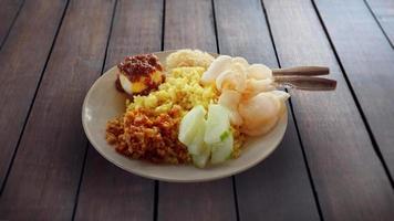 Nasi Kuning, Yellow colored rice. delicious indonesian food. photo