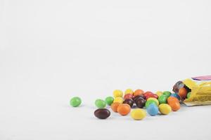 Milk chocolate peanuts with yellow packaging isolated over white background. photo