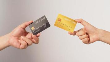 Two hands is hold black and gold credit card on white background. photo