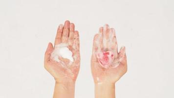 Hands washing with foaming and pink soap on white background. Studio shot photo