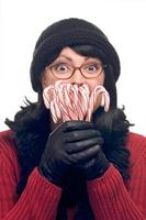 Pretty Woman Holding Candy Canes on White Background. photo