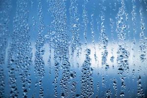 Texture of misted glass in autumn. Drops of water on window in rainy weather. photo