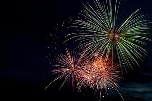 Colorful fireworks on black background. Celebration and holidays concept. Independence Day 4th of July, New Year, festival. Bright explosions of lights in sky. photo