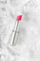 Pink lip stick in silver tube, shiny lipstick photo