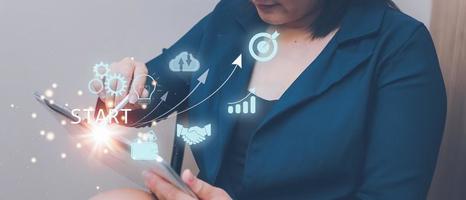Woman touching on tablet.startup concept with icon business and network connection on modern virtual interface from digital tablet. photo