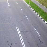 Damaged bad asphalt road with potholes. Patch repair of asphalt photo