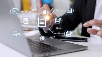 Businessman working with electronics document icons, E-document management, online documentation database, paperless office concept photo