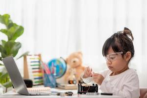 Asia students learn at home in coding robot cars and electronic board cables in STEM, STEAM, mathematics engineering science technology computer code in robotics for kids concept. photo