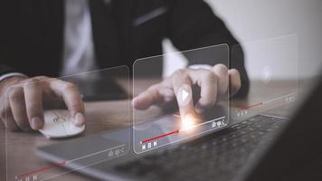 man using mouse and keyboard for streaming online, watching video on internet, live concert, show or tutorial photo
